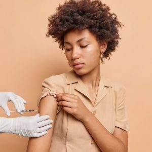 serious-curly-haired-woman-gets-vaccination-arm-immunity-health-isolated-brown-wall-31134f26 serious-curly-haired-woman-gets-vaccination-arm-immunity-health-isolated-brown-wall-31134f26
